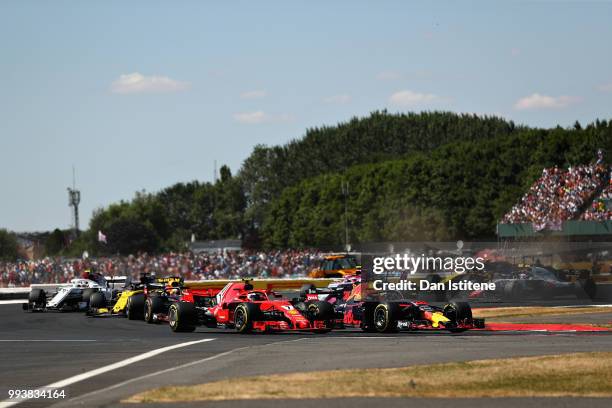 Max Verstappen of the Netherlands driving the Aston Martin Red Bull Racing RB14 TAG Heuer battles for track position with Kimi Raikkonen of Finland...