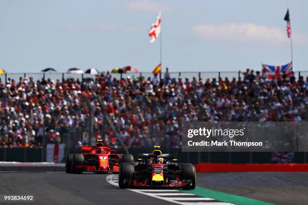 Max Verstappen of the Netherlands driving the Aston Martin Red Bull Racing RB14 TAG Heuer leads Kimi Raikkonen of Finland driving the Scuderia...