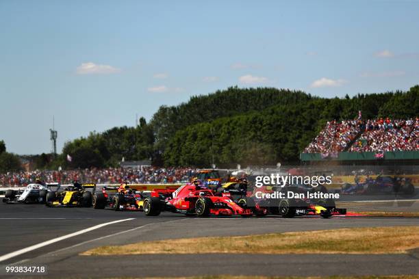 Max Verstappen of the Netherlands driving the Aston Martin Red Bull Racing RB14 TAG Heuer battles for track position with Kimi Raikkonen of Finland...