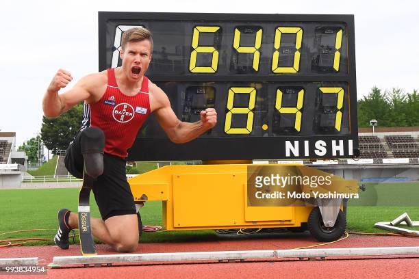 Markus Rehm of Germany poses for photographs with the display showing the new world record of 8m47 in the Men's Long Jump F64 during day two of the...