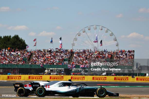 Lewis Hamilton of Great Britain driving the Mercedes AMG Petronas F1 Team Mercedes WO9 overtakes Sergey Sirotkin of Russia driving the Williams...