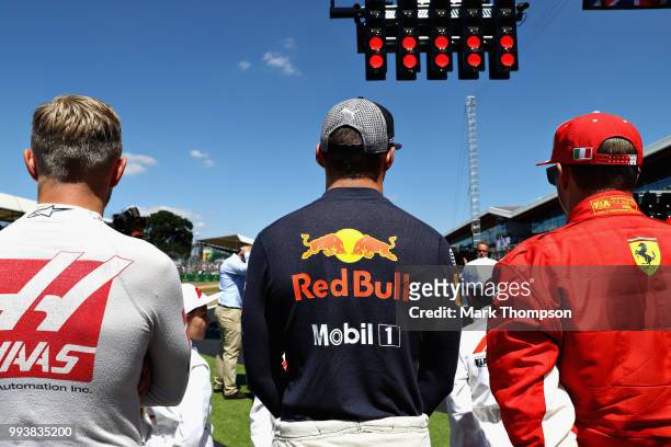 Kevin Magnussen of Denmark and Haas F1, Max Verstappen of Netherlands and Red Bull Racing and Kimi Raikkonen of Finland and Ferrari stand for the...