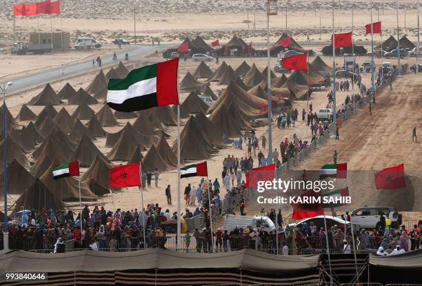 Picture taken on July 8, 2018 shows a view of Emirati and Moroccan flags flying over tents during the 14th Tan-Tan Moussem Berber festival in the...