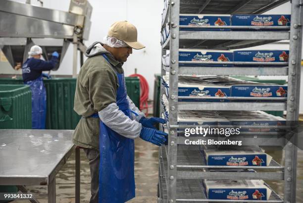 Worker adjusts boxes of shrimp on a cart at the Bowers Shrimp Farm in Palacios, Texas, U.S., on Thursday, July 5, 2018. The U.S. Census Bureau is...