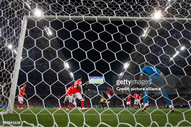 July 2018, Russia, Sotchi: Soccer: FIFA World Cup, Quarter Final: Russia vs Croatia Sotchi stadium. Russia's goalkeeper Igor Akinfeev cannot halt the...