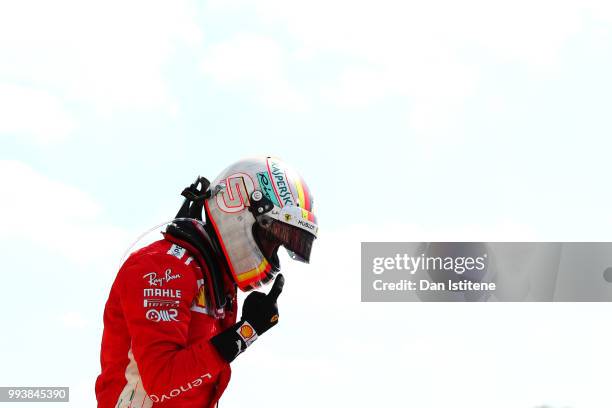 Race winner Sebastian Vettel of Germany and Ferrari celebrates in parc ferme during the Formula One Grand Prix of Great Britain at Silverstone on...