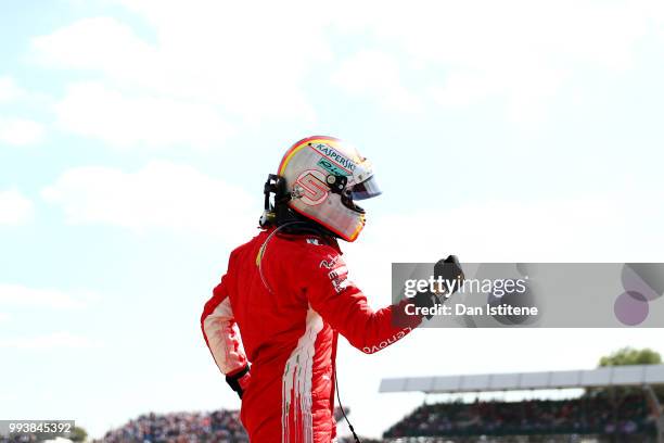 Race winner Sebastian Vettel of Germany and Ferrari celebrates in parc ferme during the Formula One Grand Prix of Great Britain at Silverstone on...