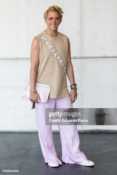 Derek Warburton wears a Loewe handbag and vintage dress during the Mercedes Benz Fashion Week Spring/Summer 2019 at IFEMA onon July 8, 2018 in...