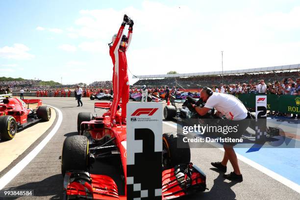 Race winner Sebastian Vettel of Germany and Ferrari celebrates in parc ferme during the Formula One Grand Prix of Great Britain at Silverstone on...