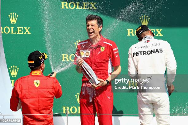 Race winner Sebastian Vettel of Germany and Ferrari celebrates on the podium during the Formula One Grand Prix of Great Britain at Silverstone on...