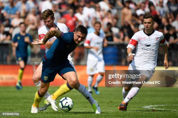 Jordan Hugill of West Ham tackles Sead Hajrovic of FC Winterthur during the preseason friendly between FC Winterthur and West Ham United on July 8,...