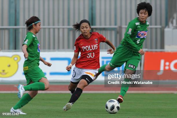 Kozue Ando of Urawa Red Diamonds and Mayo Doko of NTV Beleza compete for the ball during the Nadeshiko League Cup Group A match between Urawa Red...