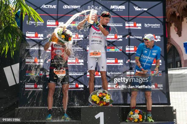 Patrik Nilsson of Sweden, Jan Frodeno of Germany and Patrick Lange of Germany pose for a picture during the flower ceremony of the Mainova IRONMAN...