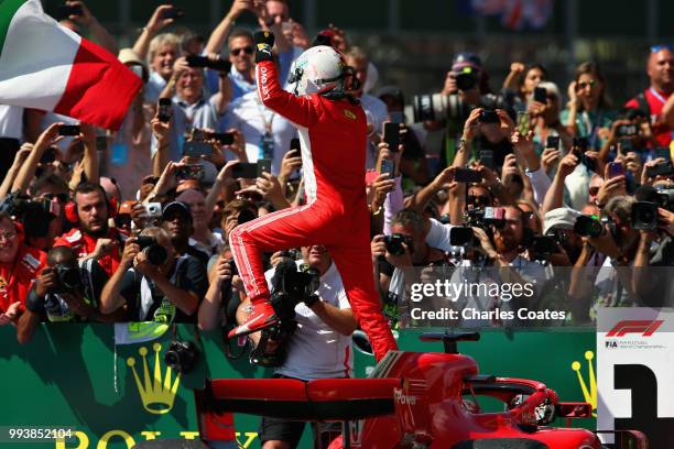 Race winner Sebastian Vettel of Germany and Ferrari celebrates in parc ferme during the Formula One Grand Prix of Great Britain at Silverstone on...