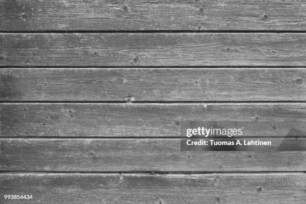 full frame background of an old and faded wood board wall in black and white - wood frame ストックフォトと画像