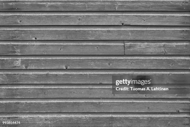 full frame background of an old and faded wood board wall in black and white - wood frame ストックフォトと画像