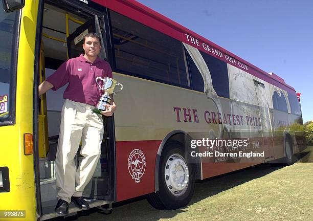 Scott Gardiner of Australia catches the bus with the Stonehaven Cup at the launch of the Holden Australian Open Golf Championships which will be held...