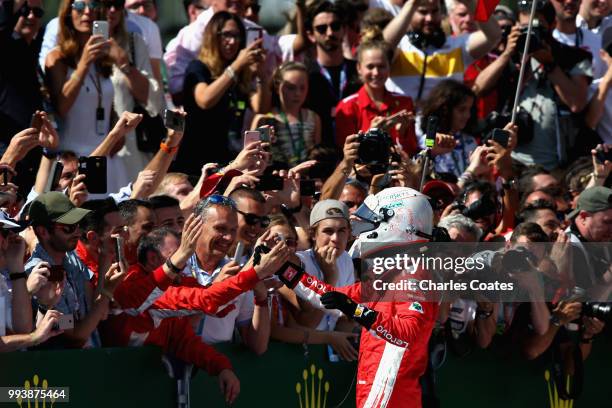 Race winner Sebastian Vettel of Germany and Ferrari celebrates in parc ferme during the Formula One Grand Prix of Great Britain at Silverstone on...