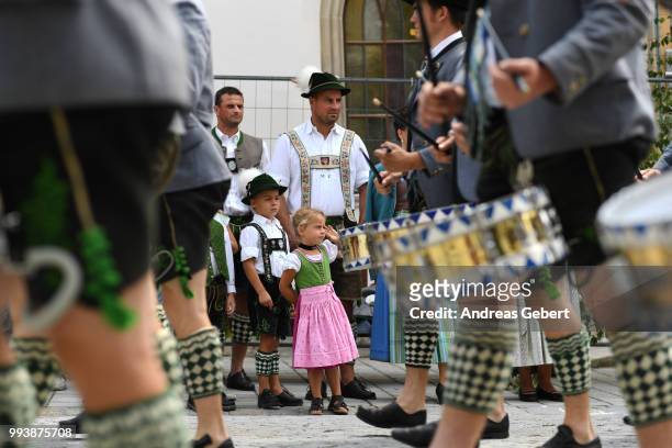 Boy and a girl in traditional Bavarian costumes attend a parade celebrating the 125th anniversary of the local Gebirgstrachten-Erhaltungsverein on...
