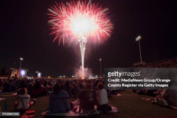 Residents watch fireworks from the field at Fred Kelly Stadium during the City of Orange's annual Third of July Celebration in Orange on Tuesday,...