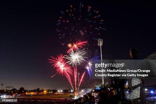 Residents watch fireworks from the top of the stands during the City of Orange's annual Third of July Celebration at Fred Kelly Stadium in Orange on...