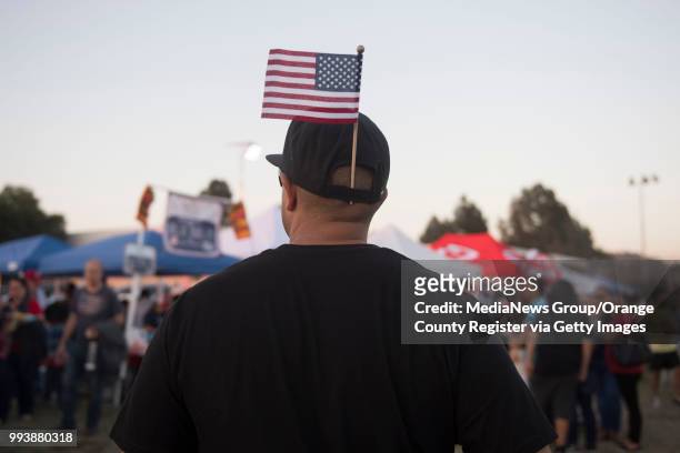 Patriotic resident wanders the food booths during the City of Orange's annual Third of July Celebration at Fred Kelly Stadium in Orange on Tuesday,...