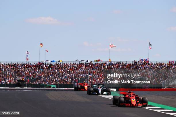 Sebastian Vettel of Germany driving the Scuderia Ferrari SF71H leads Lewis Hamilton of Great Britain driving the Mercedes AMG Petronas F1 Team...