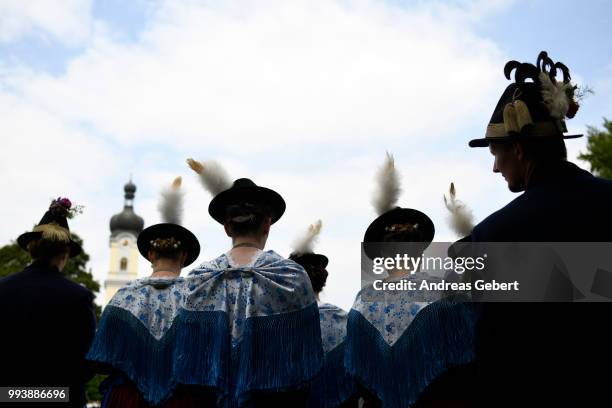 People in traditional Bavarian costums attend a catholic service on the occasion of the 125th anniversary of the local...