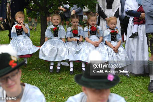 Girls in traditional Bavarian costums attend a catholic service on the occasion of the 125th anniversary of the local...