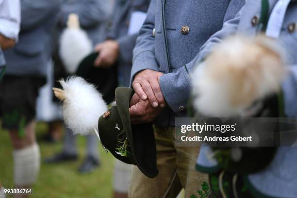 Men in traditional Bavarian costums attend a catholic service on the occasion of the 125th anniversary of the local Gebirgstrachten-Erhaltungsverein...