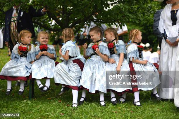Girls in traditional Bavarian costums attend a catholic service on the occasion of the 125th anniversary of the local...
