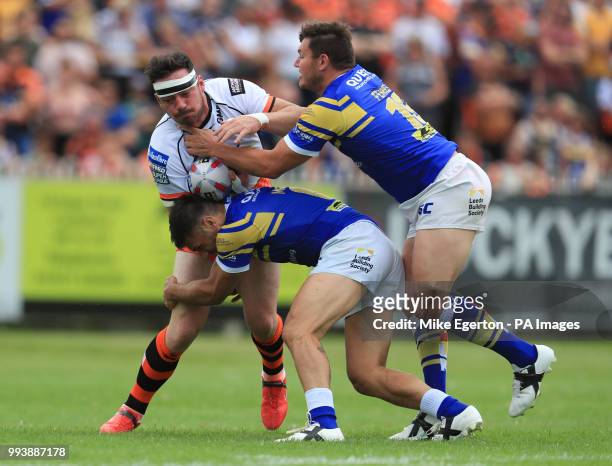 Leeds Rhinos' Brett Ferres and Joel Moon tackle Castleford's Grant Millington during the Betfred Super League match at the Mend-A-Hose-Jungle,...