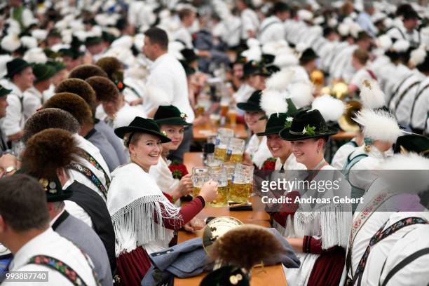 Girls in traditional Bavarian costums sit in a beer tent during the 125th anniversary of the local Gebirgstrachten-Erhaltungsverein Murnau on July 8,...