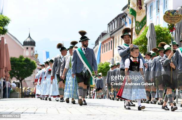 People in traditional Bavarian costums attend a parade celebrating the 125th anniversary of the local Gebirgstrachten-Erhaltungsverein Murnau on July...