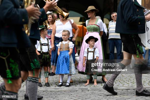 Boy and a girl in traditional Bavarian costums attend a parade celebrating the 125th anniversary of the local Gebirgstrachten-Erhaltungsverein Murnau...
