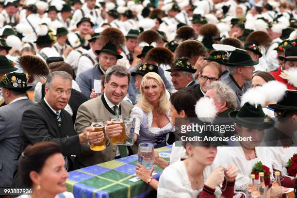 Harald Kuehn , member of the Bavarian parliament, Markus Soeder , Prime Minister of Bavaria, and his wife Karin, sit in a beer tent during the 125th...