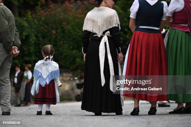 People in traditional Bavarian costums attend a parade celebrating the 125th anniversary of the local Gebirgstrachten-Erhaltungsverein Murnau on July...