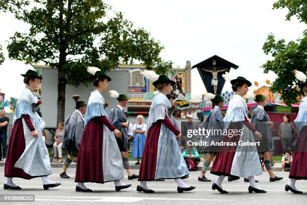 People in traditional Bavarian costums attend a parade celebrating the 125th anniversary of the local Gebirgstrachten-Erhaltungsverein Murnau on July...