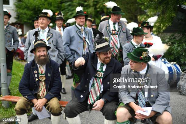 People chat prior to a catholic service on the occasion of the 125th anniversary of the local Gebirgstrachten-Erhaltungsverein Murnau on July 8, 2018...