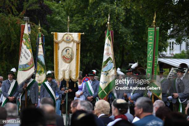 People attend a catholic service, one of them holding a flag with a portrait of former Bavarian king Ludwig II. On the occasion of the 125th...