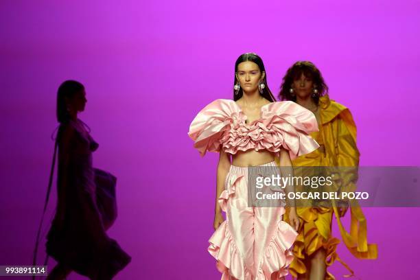 Models display outfits of Spanish designer Maria Escote Spring/Summer 2019 collection during the Madrid's Mercedes Benz Fashion Week on July 08, 2018.