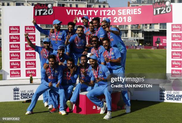 India's players celebrate with the series trophy after the third international Twenty20 cricket match between England and India at The Brightside...