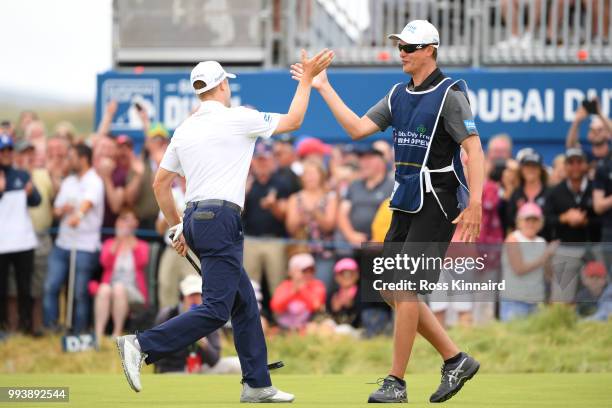 Russell Knox of Scotland celebrates holing a putt for victory on the 18th green with his caddie James Williams during a playoff at the end of the...