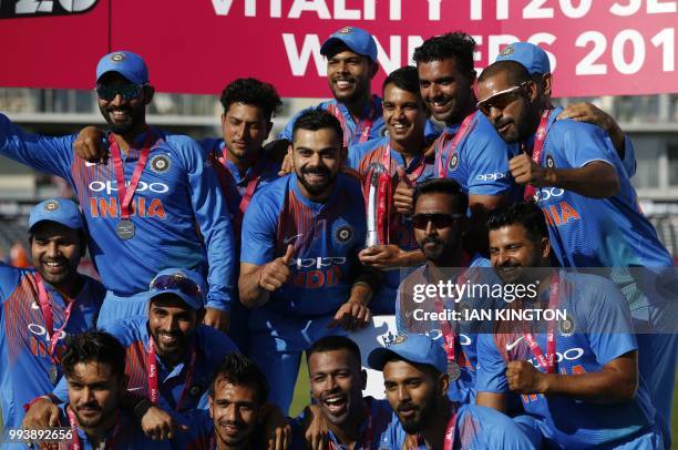 India's players celebrate with the series trophy after the third international Twenty20 cricket match between England and India at The Brightside...