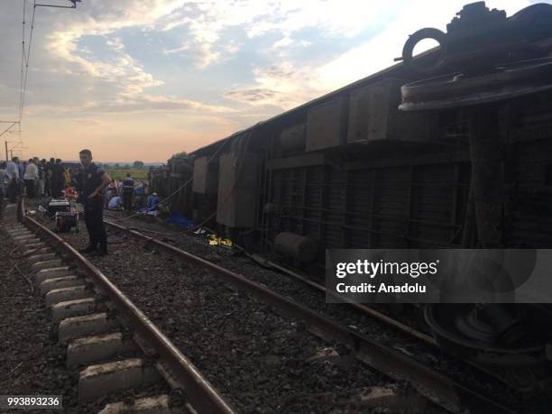 People inspect the scene after several bogies of a passenger train derailed at the Sarilar village of Tekirdags Corlu district on July 8, 2018. The...