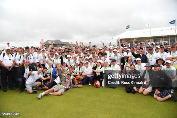 Russell Knox of Scotland poses with marshalls and volunteers following his victory on the 18th green during a playoff at the end of the final round...