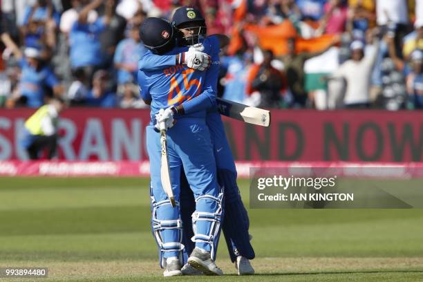 India's Rohit Sharma and India's Hardik Pandya celebrate after hitting the winning runs during the third international Twenty20 cricket match between...