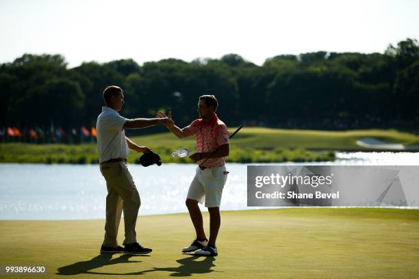 Auburn head coach Nick Clinard congratulates Brandon Mancheno of Auburn on the 18th green during the Division I Men's Golf Individual Stroke Play...