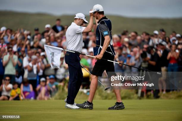 Donegal , Ireland - 8 July 2018; Russell Knox of Scotland celebrates with his caddie James Williams after his winning birdie putt on the 18th green...