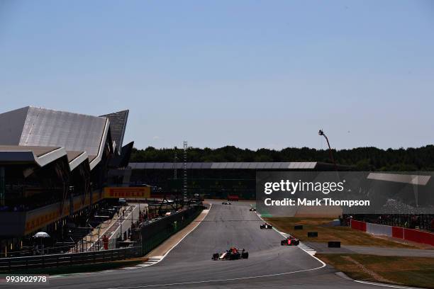 Max Verstappen of the Netherlands driving the Aston Martin Red Bull Racing RB14 TAG Heuer leads Kimi Raikkonen of Finland driving the Scuderia...